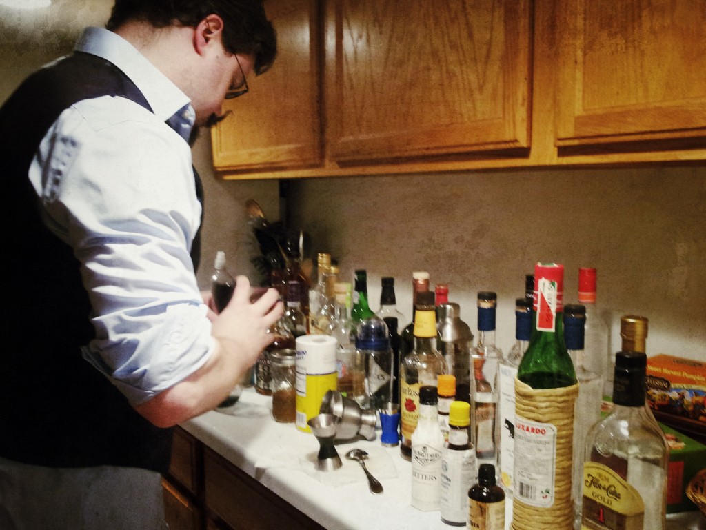 Image of a J mixing a cocktail 